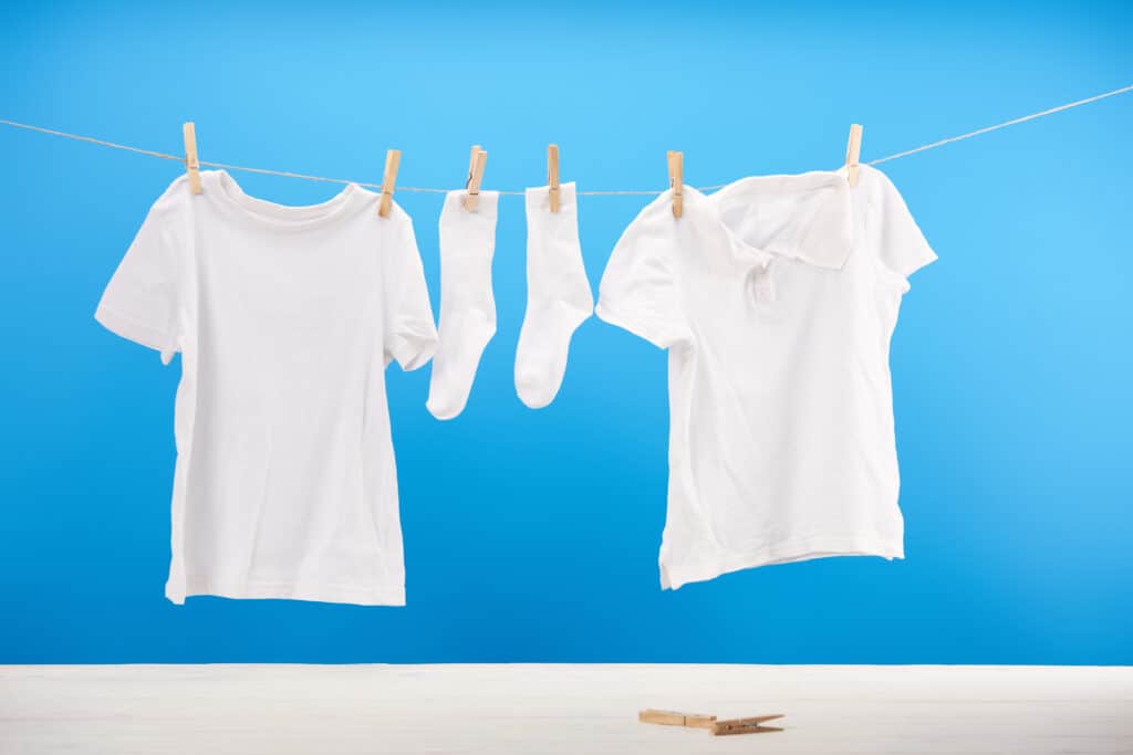 Clean white socks and t-shirts hanging on clothesline